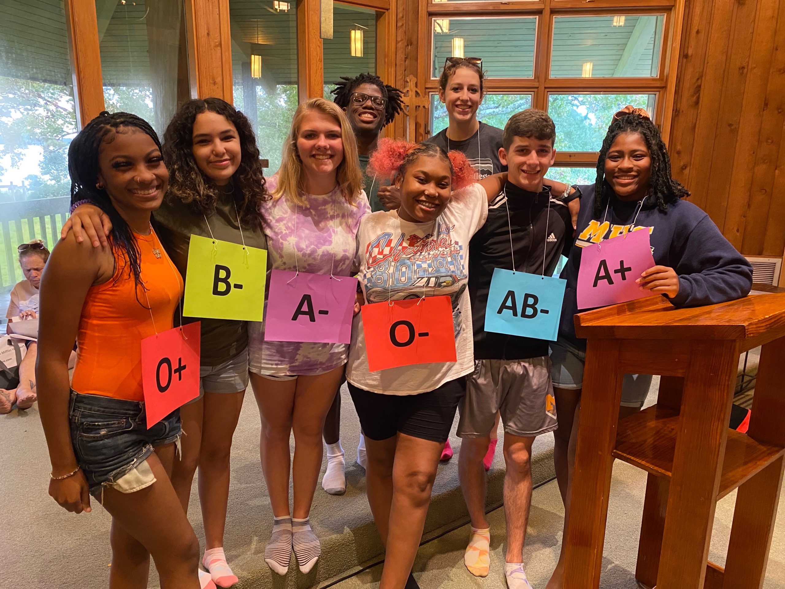 Youth group holding blood type signs